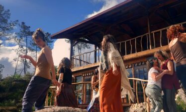 Group of participants in a Bali yoga retreat session discussing wellness and mindfulness practices.